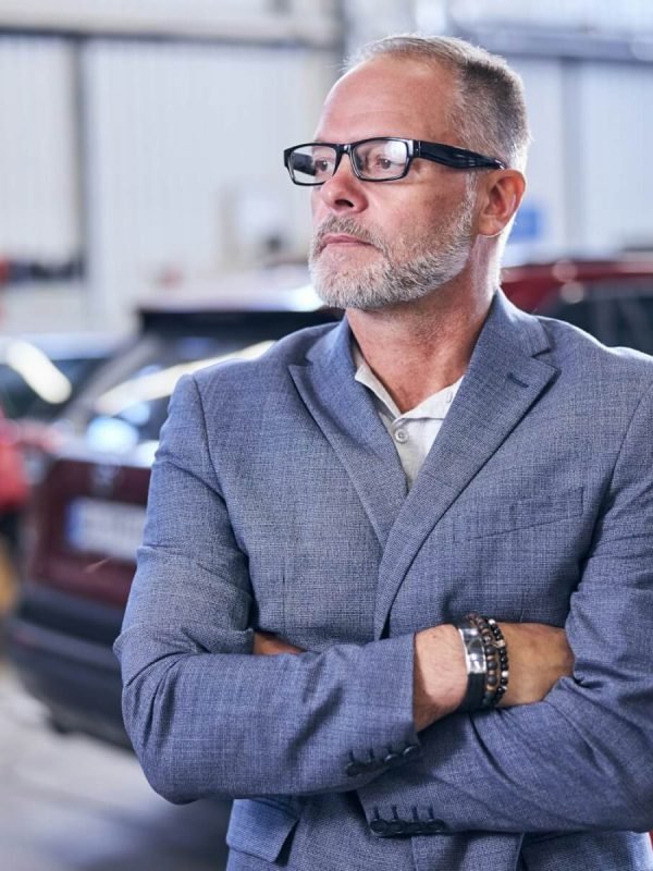 good-looking-bearded-man-standing-in-auto-repair-shop.jpg